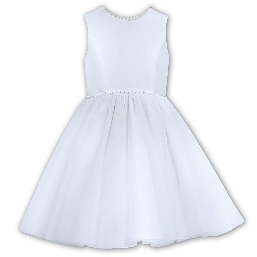 Sarah Louise Ceremonial Ballerina White Dress in a elegant sleeveless design with a V-Shaped back adorned with a pearl trim and a large bow.