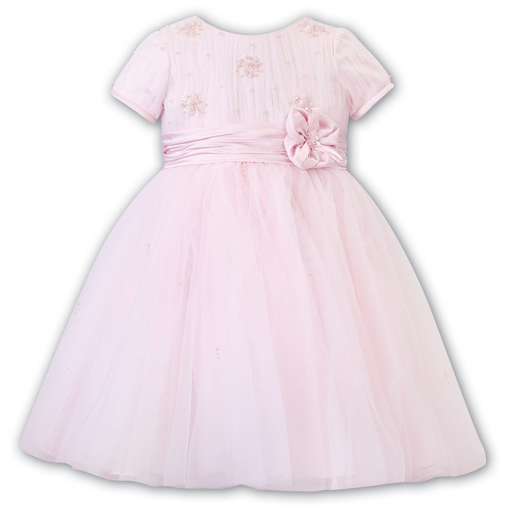 Sarah Louise Ceremonial Ballerina Dress in a delicate hand-pleated bodice with clusters of flowers adorned with pearls and a beautiful Satin flower at the waist.