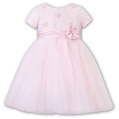 Sarah Louise Ceremonial Ballerina Dress in a delicate hand-pleated bodice with clusters of flowers adorned with pearls and a beautiful Satin flower at the waist.