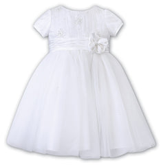 Sarah Louise Ceremonial Ballerina Dress in white, a delicate hand-pleated bodice with clusters of flowers adorned with pearls and a beautiful Satin flower at the waist.