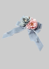 Mayoral light blue-gray velvet ribbon hair bow embellished with two fabric flowers, one in dusty blue-gray and one in soft pink.