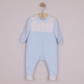 EMILE et ROSE Monty Sumptuous white and blue velour is the fabric of choice for this lovely cosy babygrow. The top of the garment is white with beautifully embroidered, alternate vertical columns of spots, diamonds and crosses. Below the soft blue collar are three pearlised buttons, the rest of the garment is pale blue with contrasting white feet.