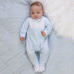 EMILE et ROSE Monty Sumptuous white and blue velour is the fabric of choice for this lovely cosy babygrow. The top of the garment is white with beautifully embroidered, alternate vertical columns of spots, diamonds and crosses. Below the soft blue collar are three pearlised buttons, the rest of the garment is pale blue with contrasting white feet.
