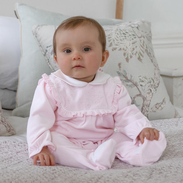 EMILE et ROSE Maddy is a beautiful baby girls babygrow in sumptuous pink velour. With its intricate flower embroidered, frilled inset yoke and pretty scalloped collar this is a very feminine outfit. Pink and white feet with little satin bows completes this gorgeous all in one.