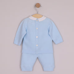 EMILE et ROSE Malachi soft knitwear in a pale blue knitted two piece. The main feature of this style is a textured criss-cross design across the chest. This pattern continues around the sleeves and the ankle of the leggings. Finishing touches include a crisp white collar, pearlised buttons , all topped off with a cute coordinating hat.