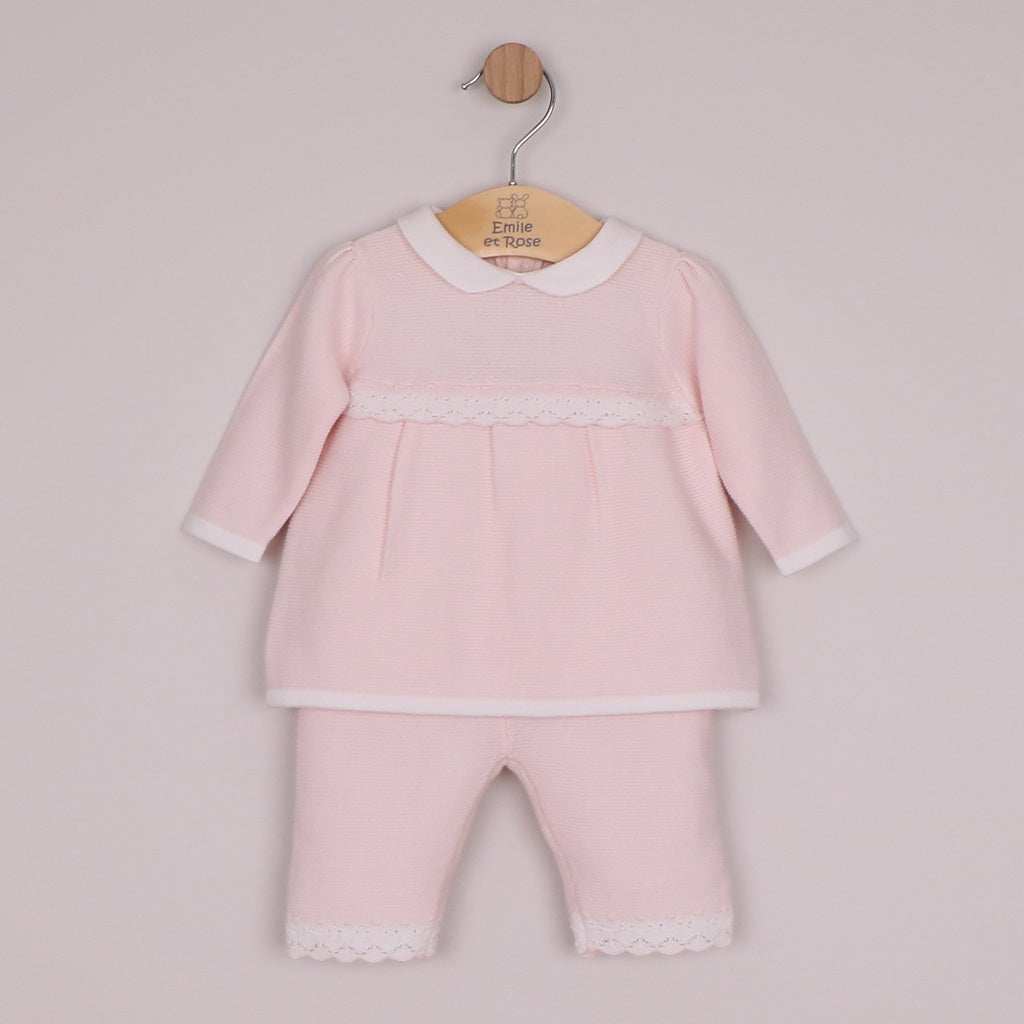 EMILE et ROSE Melanie knitted two-piece has so many beautiful elements making a truly special outfit. Combining a variety of different stitches and white lace scallop crocheted hems, the top is simply stunning. A neat, white, rounded collar and sweet little pearlised buttons add additional detailing to this lovely garment. The knitted trousers also have the same white, crocheted lace effect scallop hems