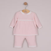 EMILE et ROSE Melanie knitted two-piece has so many beautiful elements making a truly special outfit. Combining a variety of different stitches and white lace scallop crocheted hems, the top is simply stunning. A neat, white, rounded collar and sweet little pearlised buttons add additional detailing to this lovely garment. The knitted trousers also have the same white, crocheted lace effect scallop hems