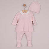 Minny is our new look two-piece, perfect for any occasion. The top is beautifully knitted with a variety of different stitches in a flower pattern. A neat white, pink spot embroidered, scalloped collar and pearlised buttons add additional detailing to this lovely garment. The new style, foot-in leggings have the same textured flower pattern knit on the foot, matching the body of the top. A stretchy waist for baby's comfort and a matching pull on hat completes this cosy set.