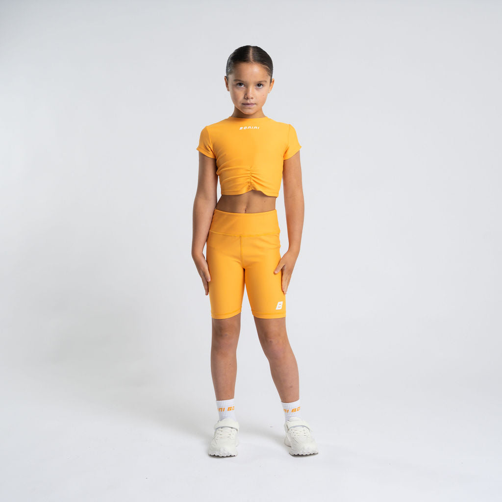 BONINI by ADee Aspire cycling shorts. Made from our signature fabric, a blend of polyester and elastane for ultimate stretch and comfort, it features a printed Bonini logo on the front and back. Florida Orange