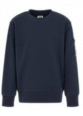 C.P. Company kids' diagonal fleece crewneck sweatshirt with iconic lens detail, digital ribbed texture, and reinforced cuffs and hem. Regular fit for everyday versatility. Navy
