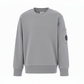 C.P. Company boys' diagonal fleece crewneck sweatshirt with iconic lens detail, ribbed texture, and reinforced cuffs and hem. Regular fit for everyday versatility. Smoke Grey