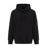 C.P. Company boys' U16 diagonal fleece adjustable hooded sweatshirt with iconic lens detail, kangaroo pocket with ribbed cuffs and hem. Regular fit. Black