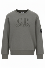 CP Company Kids sweatshirt with printed logo details and iconic lens detail, ribbed texture, and reinforced cuffs and hem. Regular fit for everyday versatility. Grey