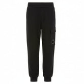 CP Company Boys Black U16 Diagonal Fllece Cargo Lens Sweatpants feature an adjustable drawstring waistband, practical side pockets, and signature cargo flap pockets with iconic Lens detailing