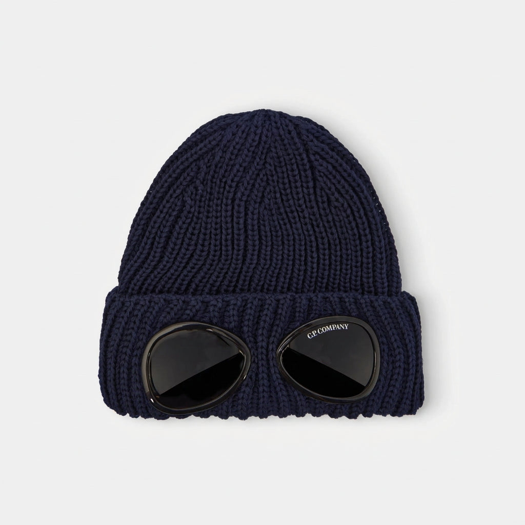 C.P. Company Kids Iconic goggle detail integrated into the turn-up brim. Dense ribbed wool creates structure and superior insulation. Adjustable turn-up brim for extra warmth. Premium construction built for daily winter wear. 100% Wool Hand wash. Navy