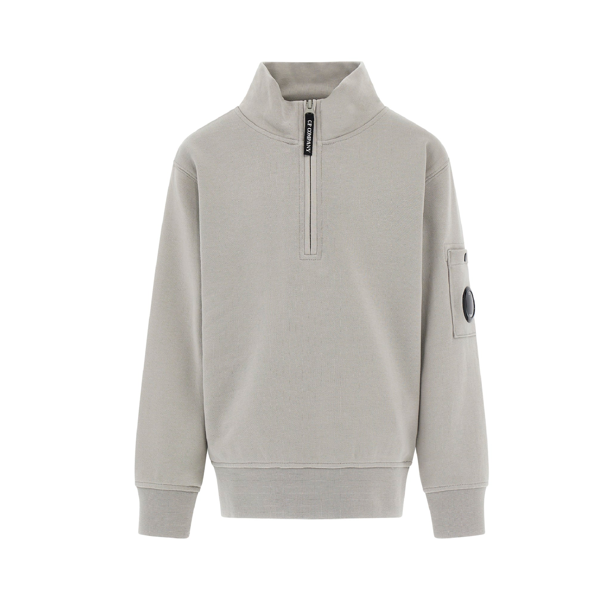C.P. Company boys' U16 diagonal fleece half zip closure, high neck sweatshirt with iconic lens detail, ribbed texture, and reinforced cuffs and hem. Regular fit for everyday versatility. Smoke Grey