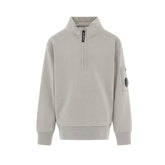 C.P. Company boys' U16 diagonal fleece half zip closure, high neck sweatshirt with iconic lens detail, ribbed texture, and reinforced cuffs and hem. Regular fit for everyday versatility. Smoke Grey