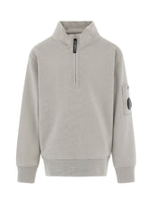 C.P. Company kids' U16 diagonal fleece half zip closure, high neck sweatshirt with iconic lens detail, ribbed texture, and reinforced cuffs and hem. Regular fit for everyday versatility. Smoke Grey