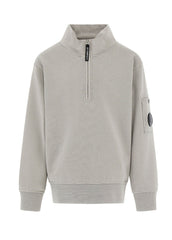 C.P. Company kids' U16 diagonal fleece half zip closure, high neck sweatshirt with iconic lens detail, ribbed texture, and reinforced cuffs and hem. Regular fit for everyday versatility. Smoke Grey