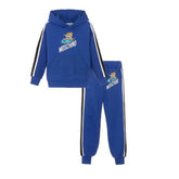 Moschino Kids Hooded Tracksuit with signature Teddy Bear motif. Classic hoodie, front pouch pocket, side stripe detail, ribbed cuffs. Track bottoms tapered leg, elasticated drawstring waistband, two side pockets and ribbed cuffs.