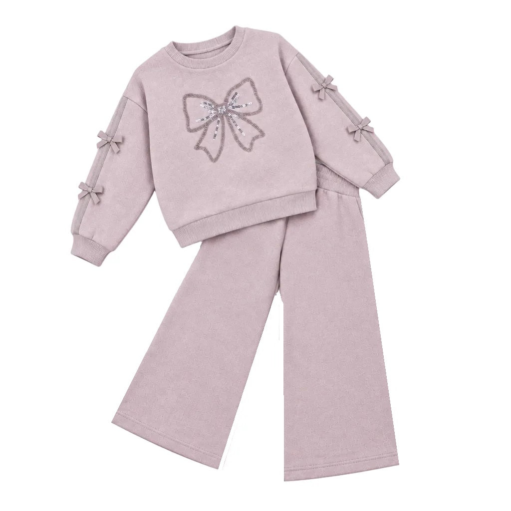 Giorgio Bambini girls light purple coloured tracksuit featuring a sequined bow detail on the front. Crafted from soft, stretchy cotton with fleece backing for warmth and comfort. Ribbed cuffs with decorative bows on the sleeves.