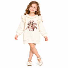 A charming dress from featuring a perfume bottle design embellished with diamante detailing. Delicate pearl and ruffles add elegance.