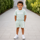 BOSS Kids Short-sleeved T-shirt in 100% cotton jersey, "BOSS" print on front. Paired with BOSS Kids surfer swim shorts.