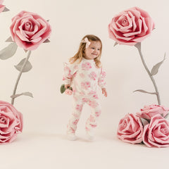 LITTLE A The Dakota tracksuit features an all-over rose print, a cosy long sleeve sweatshirt, and matching leggings. Finished with soft ribbed trims for a comfy and coordinated look.