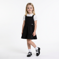 LELLI KELLY Becky Black School Pinafore featuring a charming bow detail on the back and charm with LELLI KELLY logo on the front
