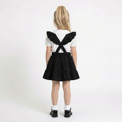 LELLI KELLY Bryony Black Frill Pinafore featuring cross over strap detail on the back and charm with LELLI KELLY logo on the front