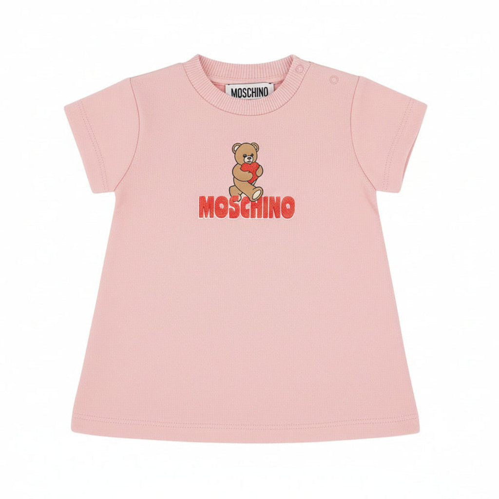 MOSCHINO Baby Pink Dress with Heart & Teddy Bear Logo A charming pink dress for baby girls, featuring the iconic MOSCHINO heart and teddy bear logo.