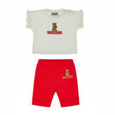 MOSCHINO baby girls set featuring a signature teddy and heart tee with coordinating short leggings in Poppy Red.