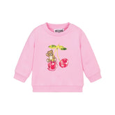 Pink cotton jersey sweatshirt by Moschino for baby girls, featuring a teddy bear and cherry motif with ribbed trims and shoulder poppers.