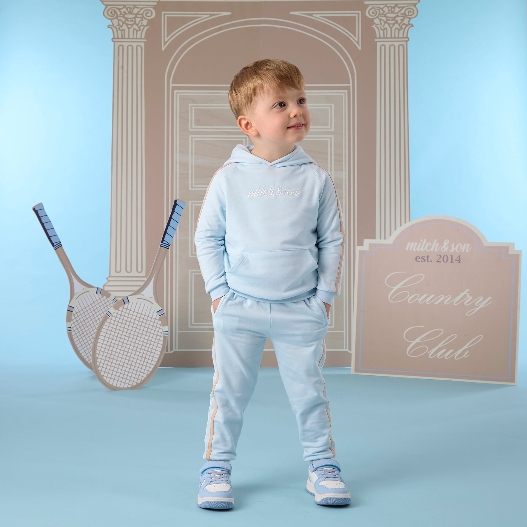 MITCH & SON Classic Collection. The Scott tracksuit features a classic overhead hoodie with a front pouch pocket and matching joggers. Designed with contrast side panels and finished with ribbed trims and signature logo detailing. Sky Blue
