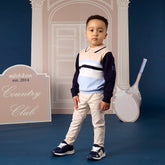 MITCH & SON Classic Collection. The Sebastian knitted polo features a colour block stripe design with a classic collar and button placket. Finished with ribbed trims and a signature chest badge. Paired with Silas trousers feature a classic woven design with a button fastening and elasticated side tabs for a comfortable fit. Finished with side and back pockets and subtle logo detailing. Stone Beige
