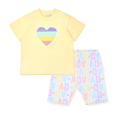 ADEE Signature Summer The Saz cycling short set features an oversized t-shirt with a sequined heart artwork on the front. Paired with initial print cycling shorts
