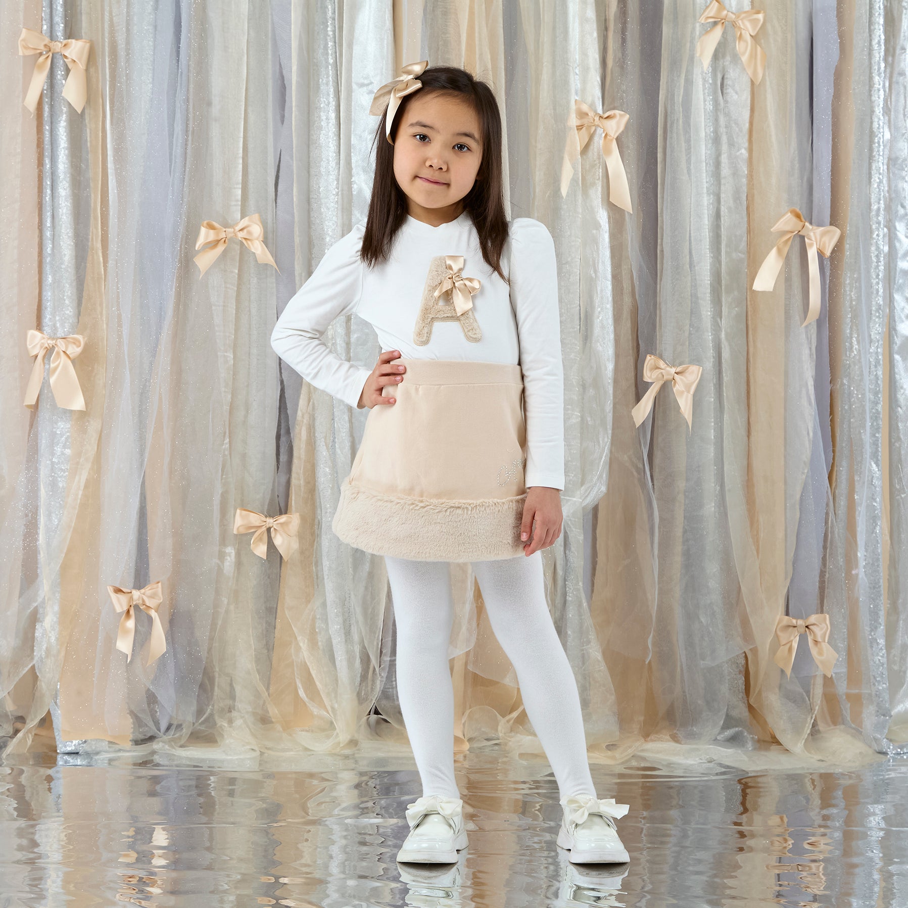 ADEE Eau de theme.The Andrea Set features a long-sleeved top with gorgeous faux fur “A” artwork on the front, paired perfectly with a beige skirt finished with soft faux fur trim. This is a winter wardrobe must have! Snow White