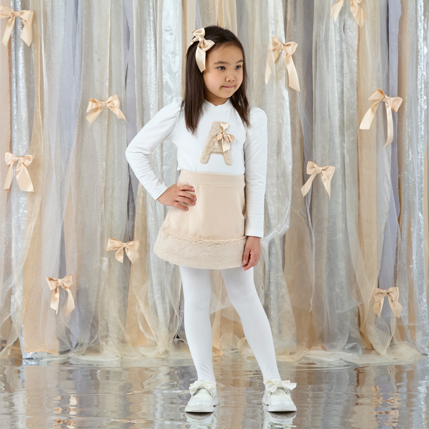 ADEE Eau de theme. The Andrea Set features a long-sleeved top with gorgeous faux fur “A” artwork on the front, paired perfectly with a beige skirt finished with soft faux fur trim. This is a winter wardrobe must have! Snow White
