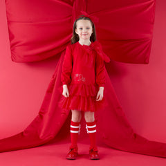 ADee The Brandy Dress features a glitter tulle double-frill skirt, long puff sleeves, and a statement appliqué bow. Perfect for festive Christmas parties. Red