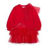 ADee The Brandy Dress features a glitter tulle double-frill skirt, long puff sleeves, and a statement appliqué bow. Perfect for festive Christmas parties. Red