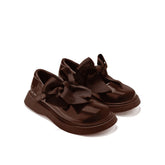 ADEE The Lyra shoe is perfect for school, with pretty bows on the velcro strap and embroidered logo to the side. Finished with non-slip rubber soles. Brown.
