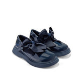 ADEE The Lyra shoe is perfect for school, with pretty bows on the velcro strap and embroidered logo to the side. Finished with non-slip rubber soles. Navy