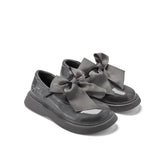ADEE The Lyra shoe is perfect for school, with pretty bows on the velcro strap and embroidered logo to the side. Finished with non-slip rubber soles. Dark Grey