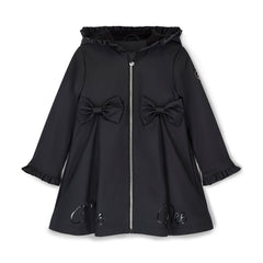 ADEE BTS The Nova is the must-have back to school raincoat! It features front and back pleats with pretty bow detailing, branding around the hem and frills at the cuffs and hood. Complete with a silver reflective logo badge on one arm and a silver branded puller. Black