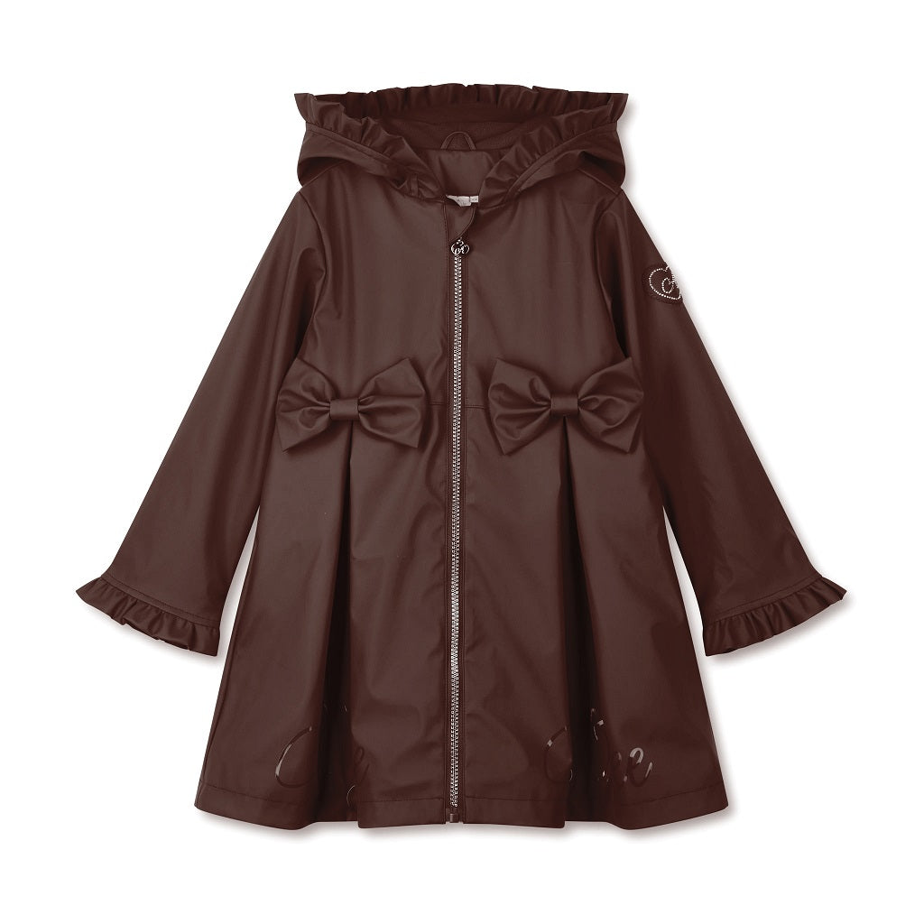 ADEE BTS The Nova is the must-have back to school raincoat! It features front and back pleats with pretty bow detailing, branding around the hem and frills at the cuffs and hood. Complete with a silver reflective logo badge on one arm and a silver branded puller. Brown
