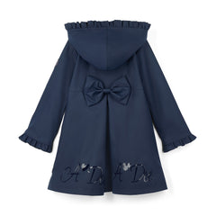 ADEE BTS The Nova is the must-have back to school raincoat! It features front and back pleats with pretty bow detailing, branding around the hem and frills at the cuffs and hood. Complete with a silver reflective logo badge on one arm and a silver branded puller. Dark Navy
