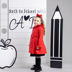 ADEE The Nova is the must-have back to school raincoat! It features front and back pleats with pretty bow detailing, branding around the hem and frills at the cuffs and hood. Complete with a silver reflective logo badge on one arm and a silver branded puller. Red