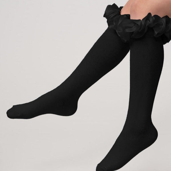 Black knee-high socks with ruffles from Caramelo Kids.