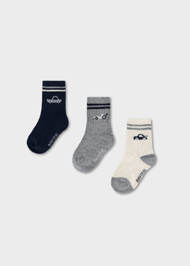 Mayoral baby boys striped socks set featuring playful car motifs across three pairs in white, blue, and grey.
