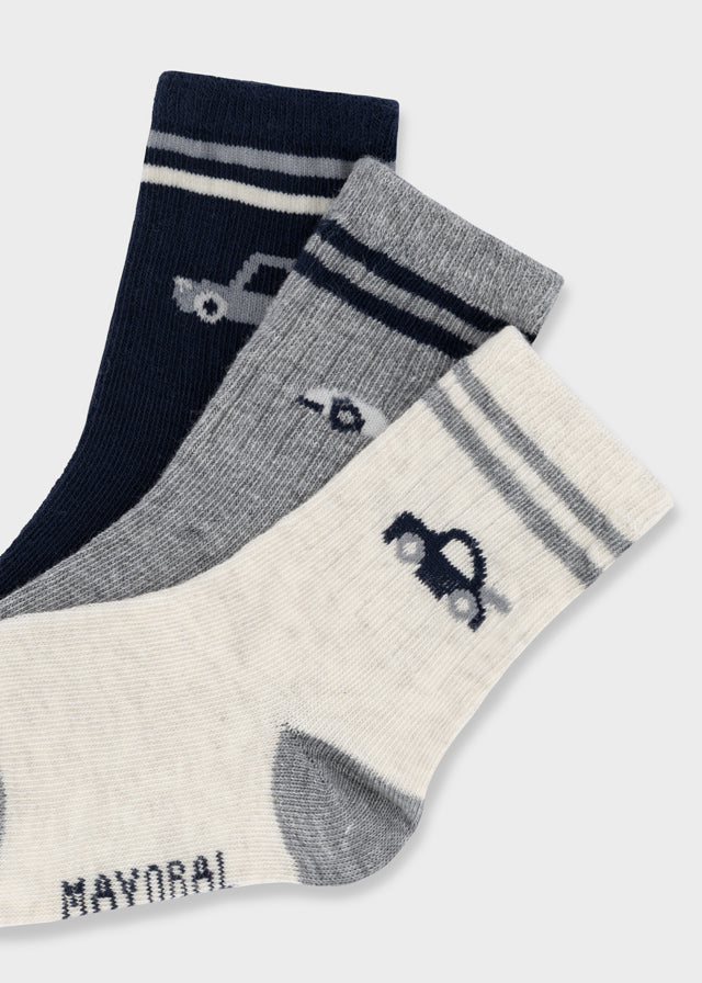 Mayoral baby boys striped socks set featuring playful car motifs across three pairs in white, blue, and grey.